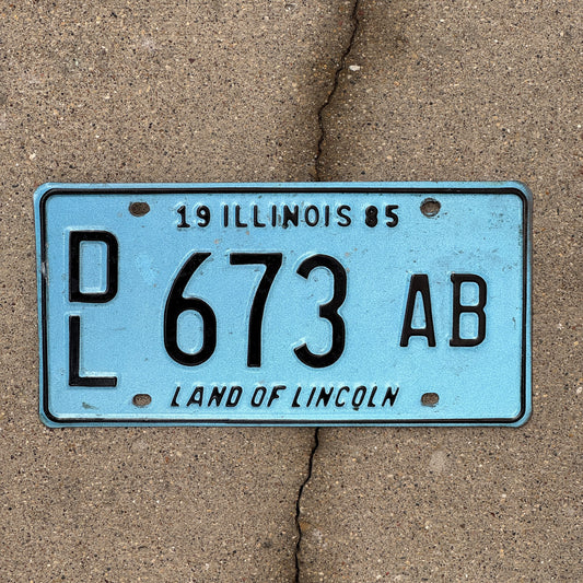 Photo of a 1985 Illinois Dealer License Plate Auto Tag 2 Vintage Garage Merritt's Sterling Ford Mercury Lincoln Dealer 673 AB with original patina