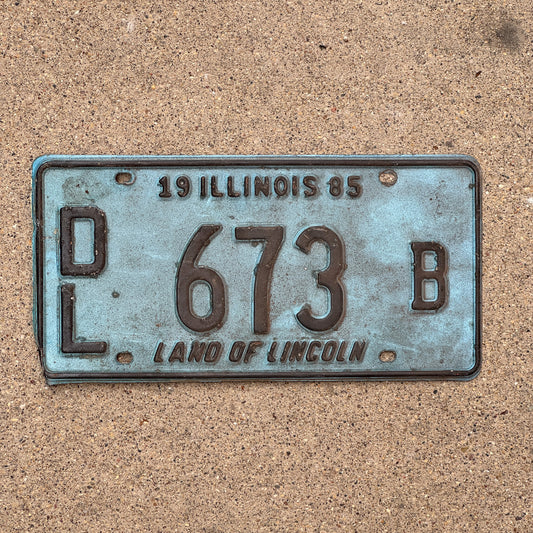 Photo of a 1985 Illinois Dealer License Plate Auto Tag 2 Vintage Garage Merritt's Sterling Ford Mercury Lincoln Dealer 673 B with original patina