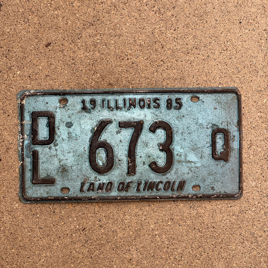 Photo of a 1985 Illinois Dealer License Plate Auto Tag 2 Vintage Garage Merritt's Sterling Ford Mercury Lincoln Dealer 673 Q with original patina