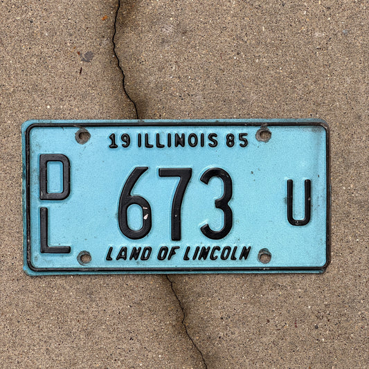 Photo of a 1985 Illinois Dealer License Plate Auto Tag 2 Vintage Garage Merritt's Sterling Ford Mercury Lincoln Dealer 673 U with original patina