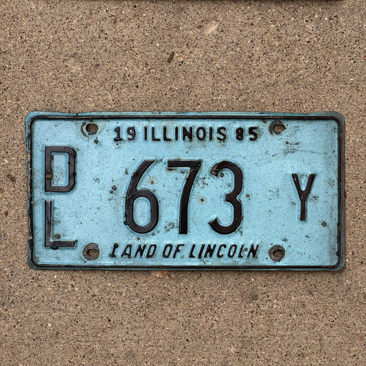 Photo of a 1985 Illinois Dealer License Plate Auto Tag 2 Vintage Garage Merritt's Sterling Ford Mercury Lincoln Dealer 673 Y with original patina