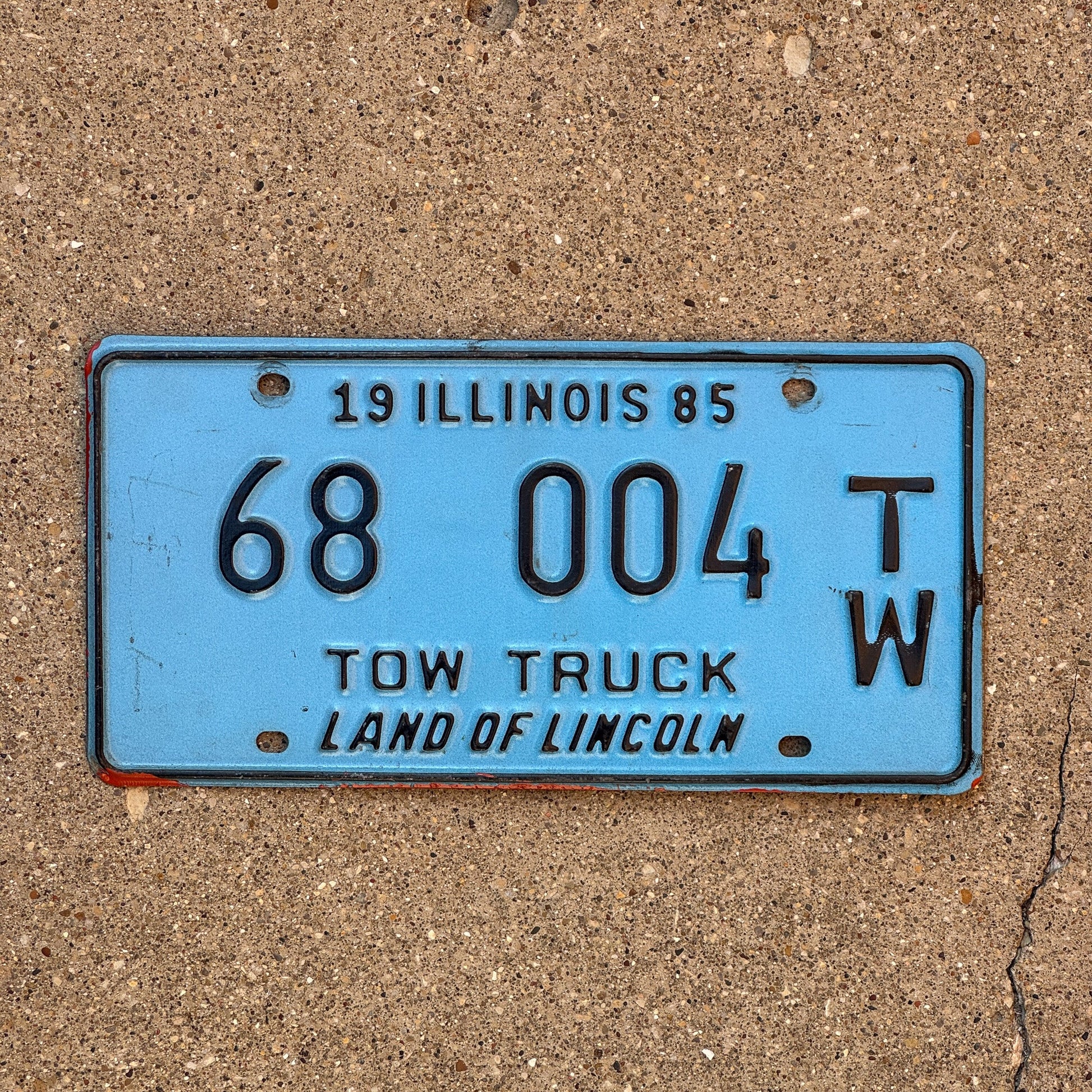 Photo of a 1985 Illinois Tow Truck License Plate Auto Tag Garage Decor Vintage 68 004 TW