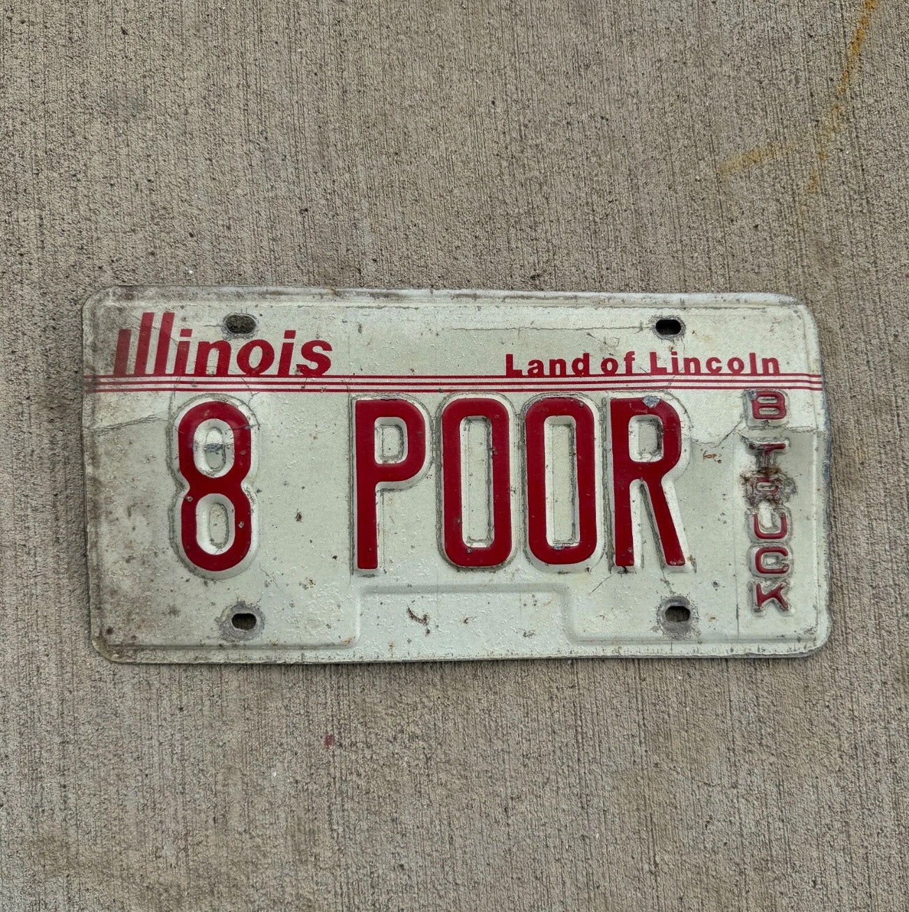 Photo of a 1985 Illinois Truck Vanity License Plate Auto Tag 2 Garage Decor Cash 8 Poor