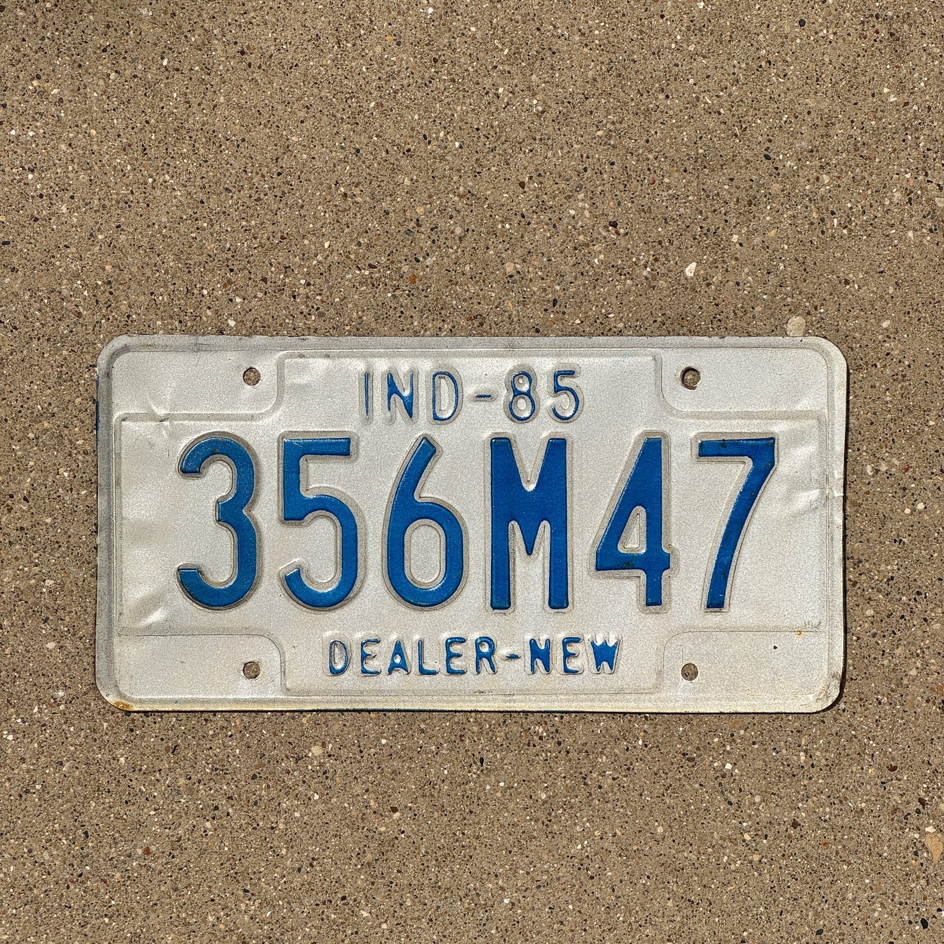 Photo of a 1985 Indiana Dealer License Plate Auto Tag Garage Decor Vintage 356 M 47