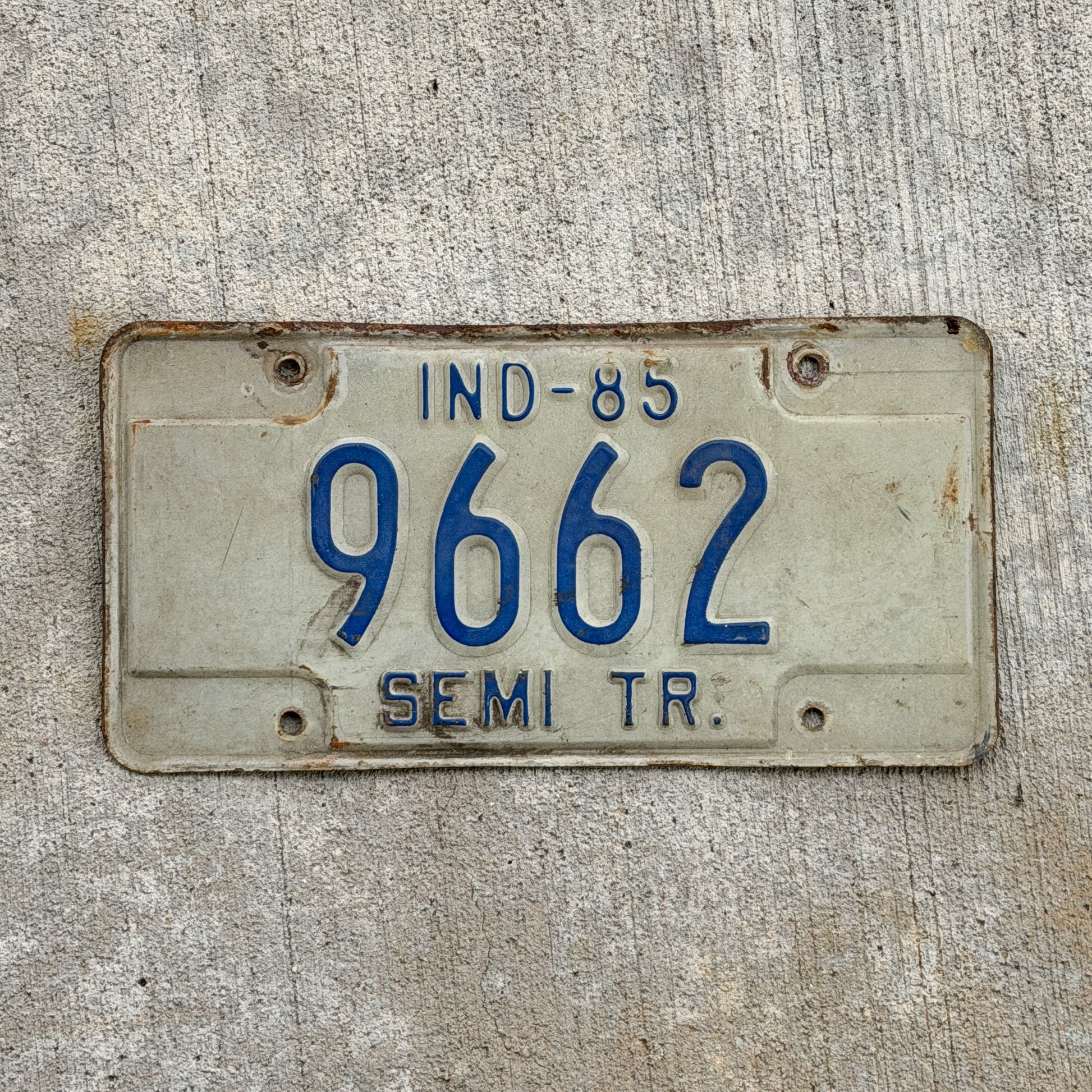 Photo of a 1985 Indiana Semi Trailer License Plate Auto Tag Garage Decor Vintage 9662 with original patina