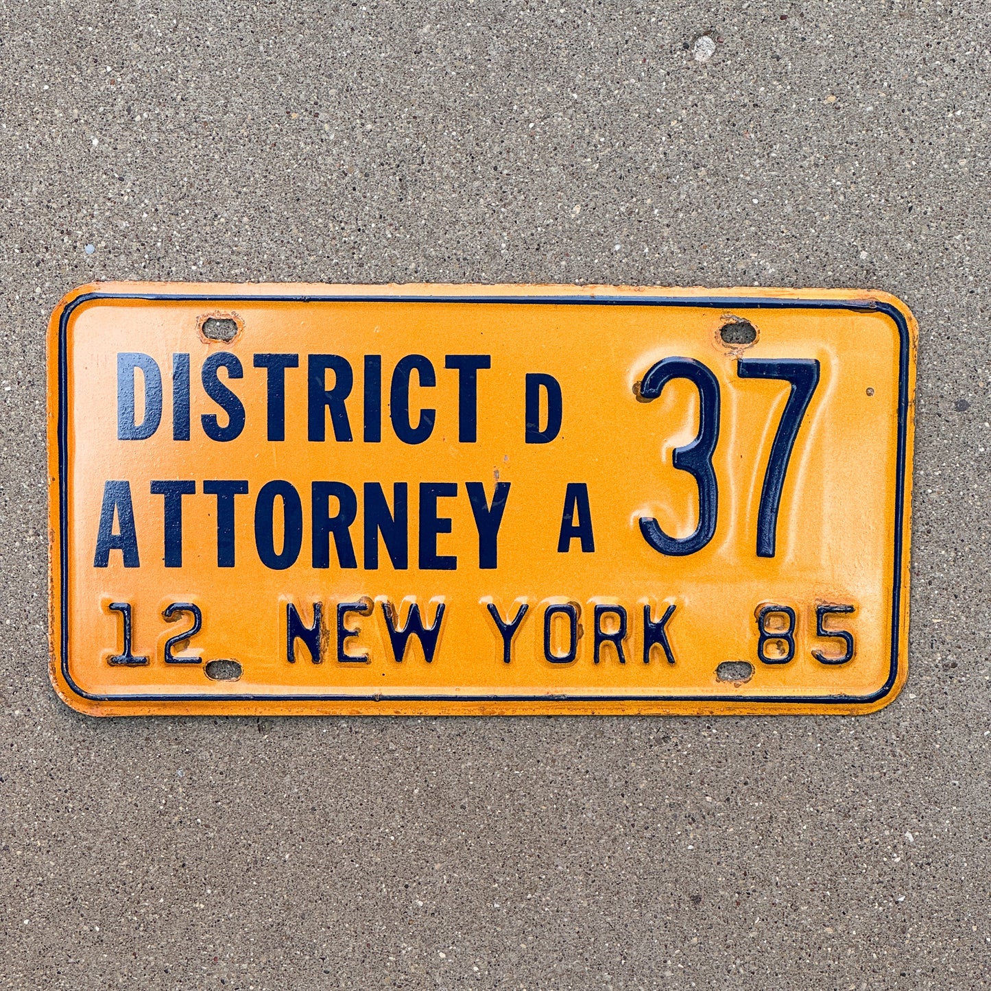 Photo of a 1985 New York District Attorney License Plate Auto Tag Garage Decor Vintage 37 with original patina
