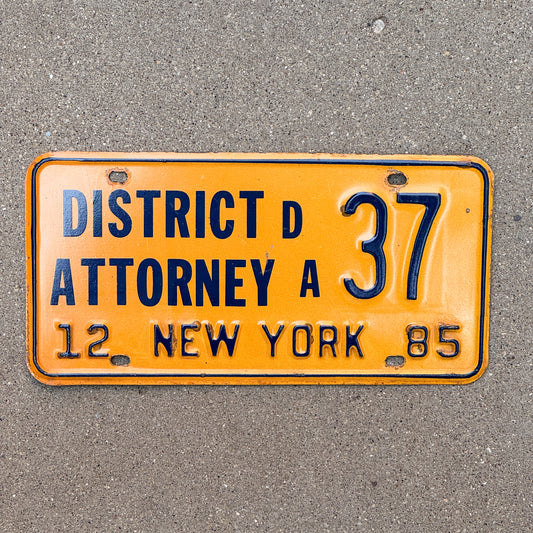 Photo of a 1985 New York District Attorney License Plate Auto Tag Garage Decor Vintage 37 with original patina