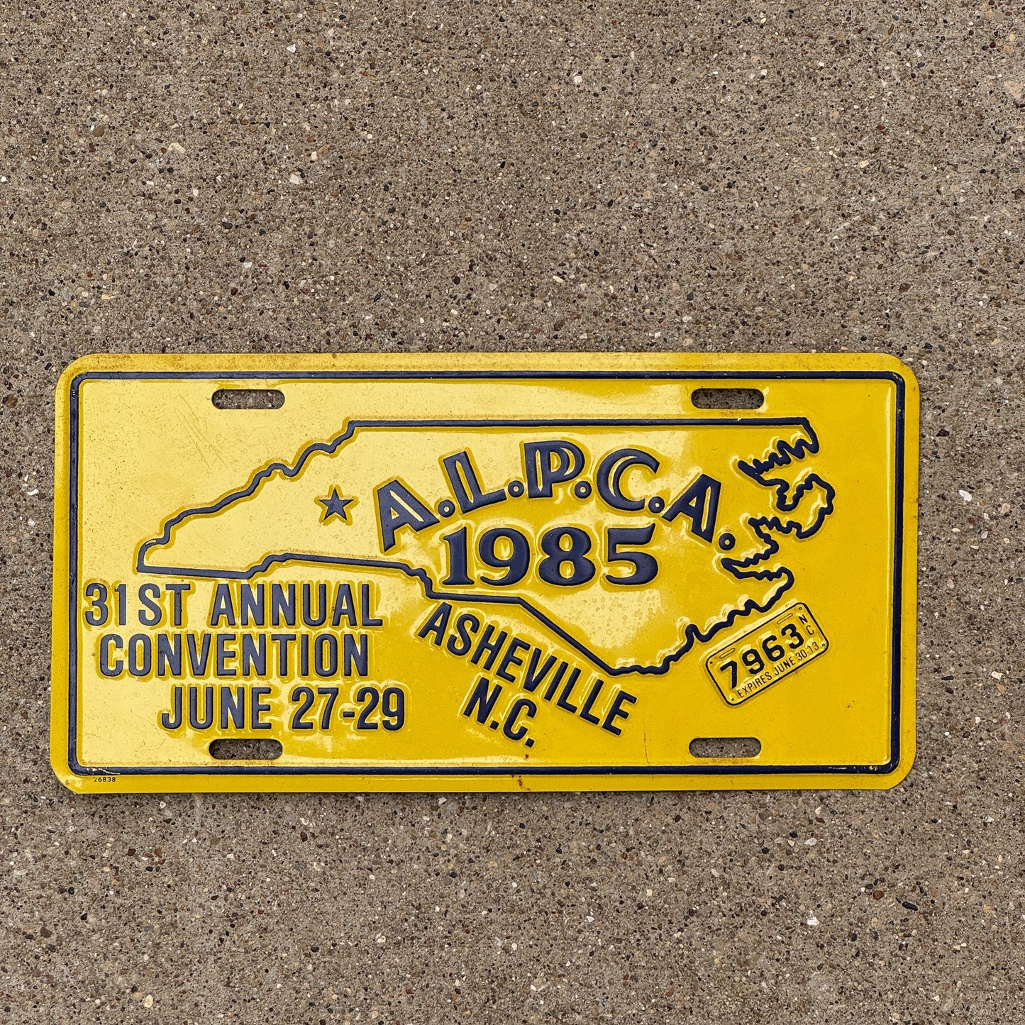 Photo of a 1985 North Carolina Booster License Plate Auto Tag Garage Decor Vintage Asheville ALPCA Convention