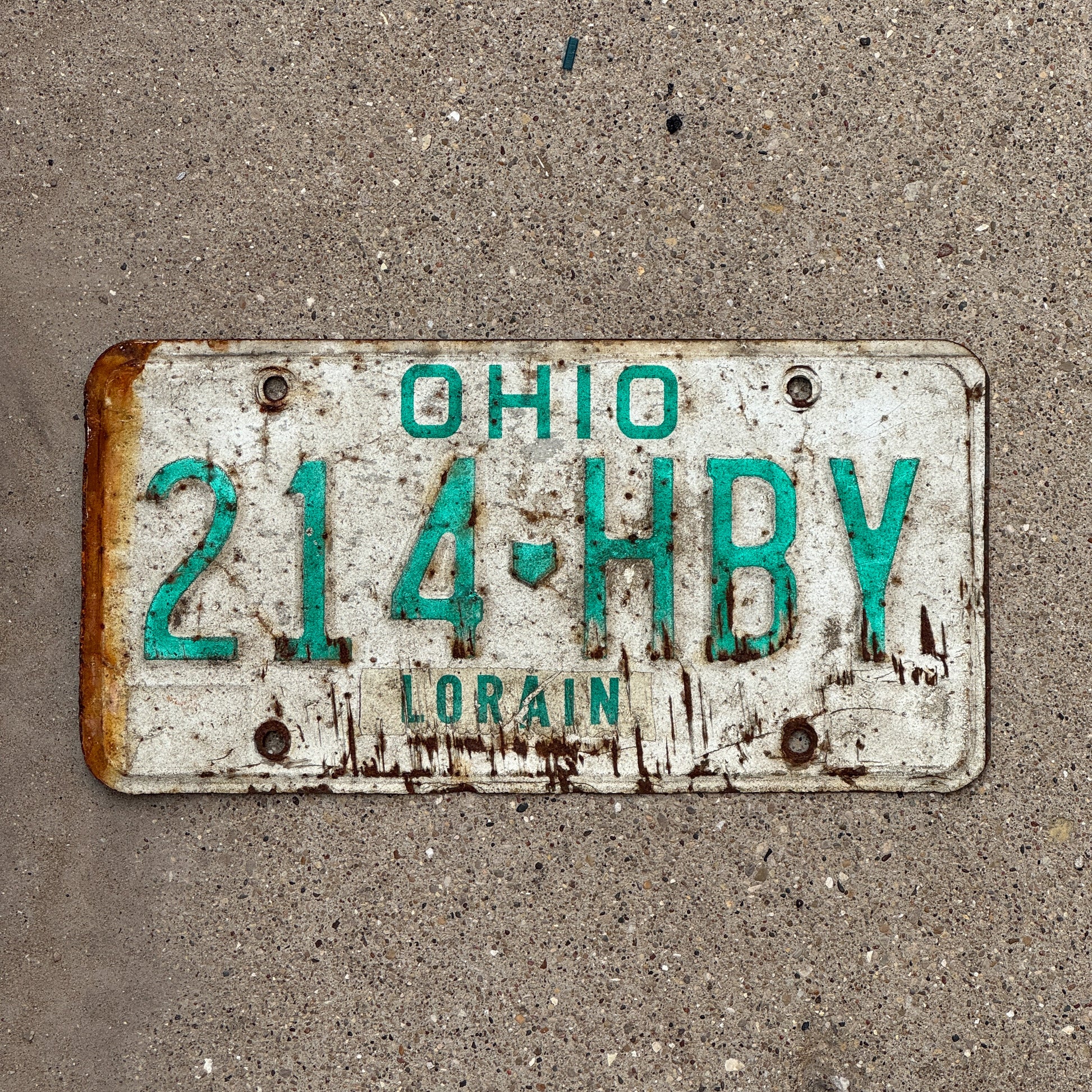 Photo of a 1985 Ohio License Plate Auto Tag 2 Vintage Garage 214 HBY with original patina