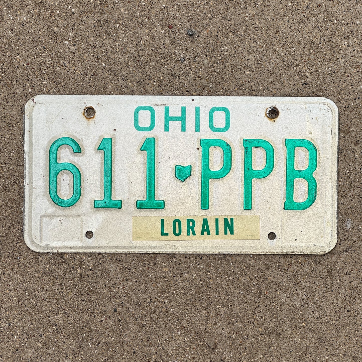 Photo of a 1985 Ohio License Plate Auto Tag 2 Vintage Garage 611 PPB with original patina