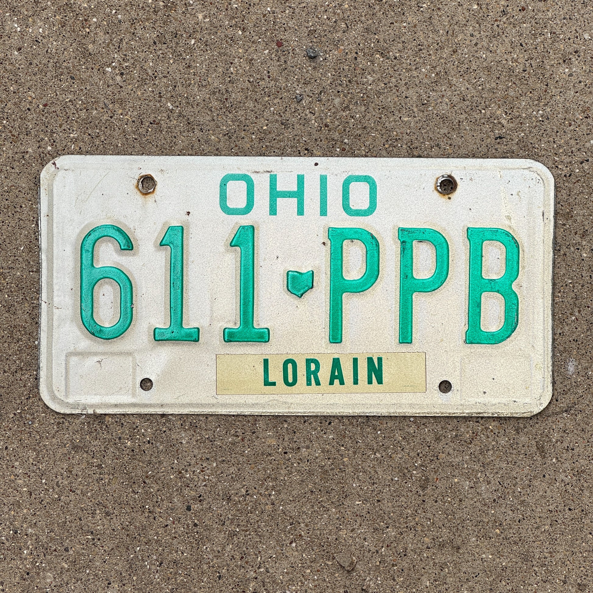 Photo of a 1985 Ohio License Plate Auto Tag 2 Vintage Garage 611 PPB with original patina