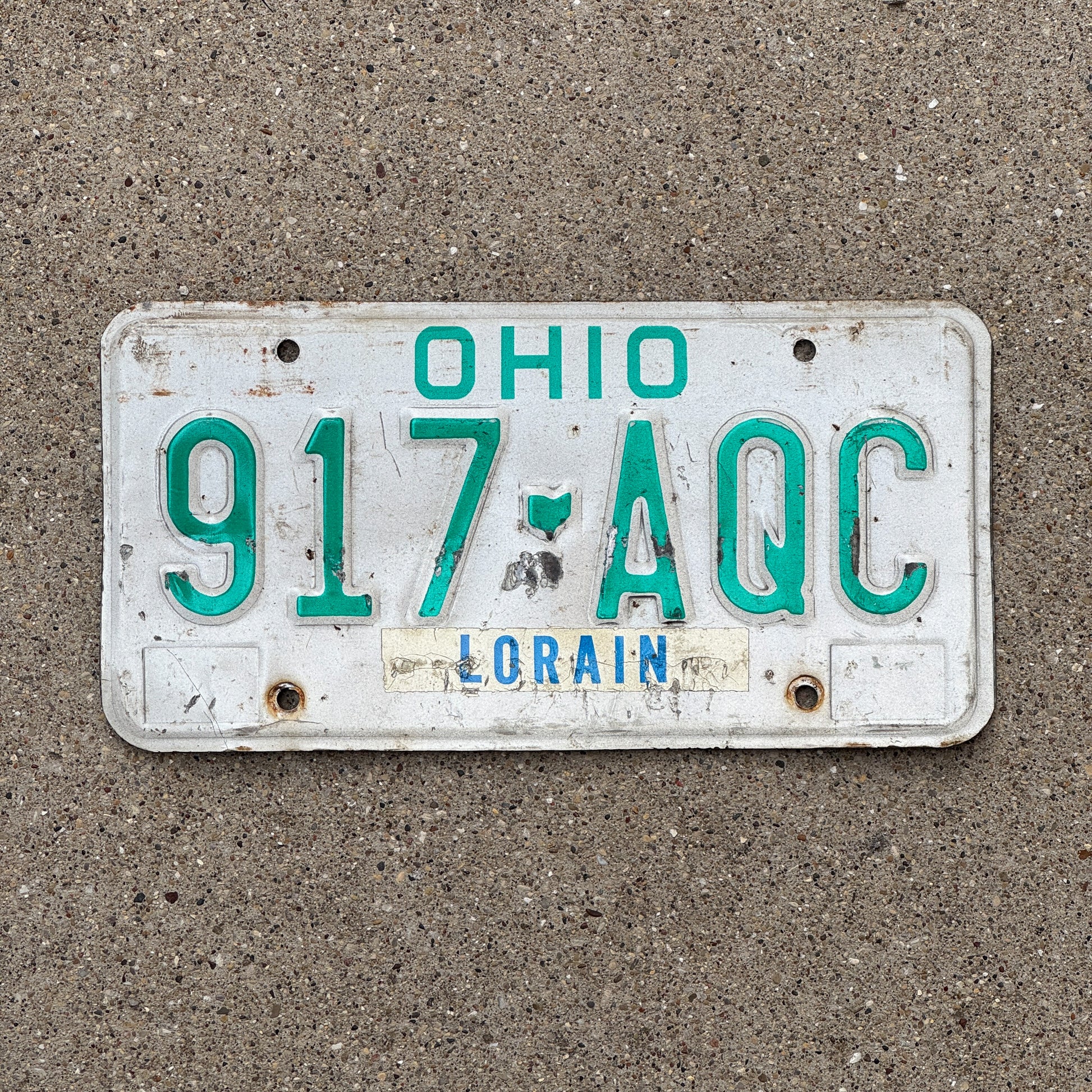 Photo of a 1985 Ohio License Plate Auto Tag 2 Vintage Garage 917 AQC with original patina