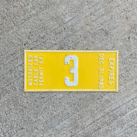 Photo of a 1985 San Francisco California Cable Car License Plate Topper Auto Tag Garage Decor Vintage Cal Low Number 3 with original patina