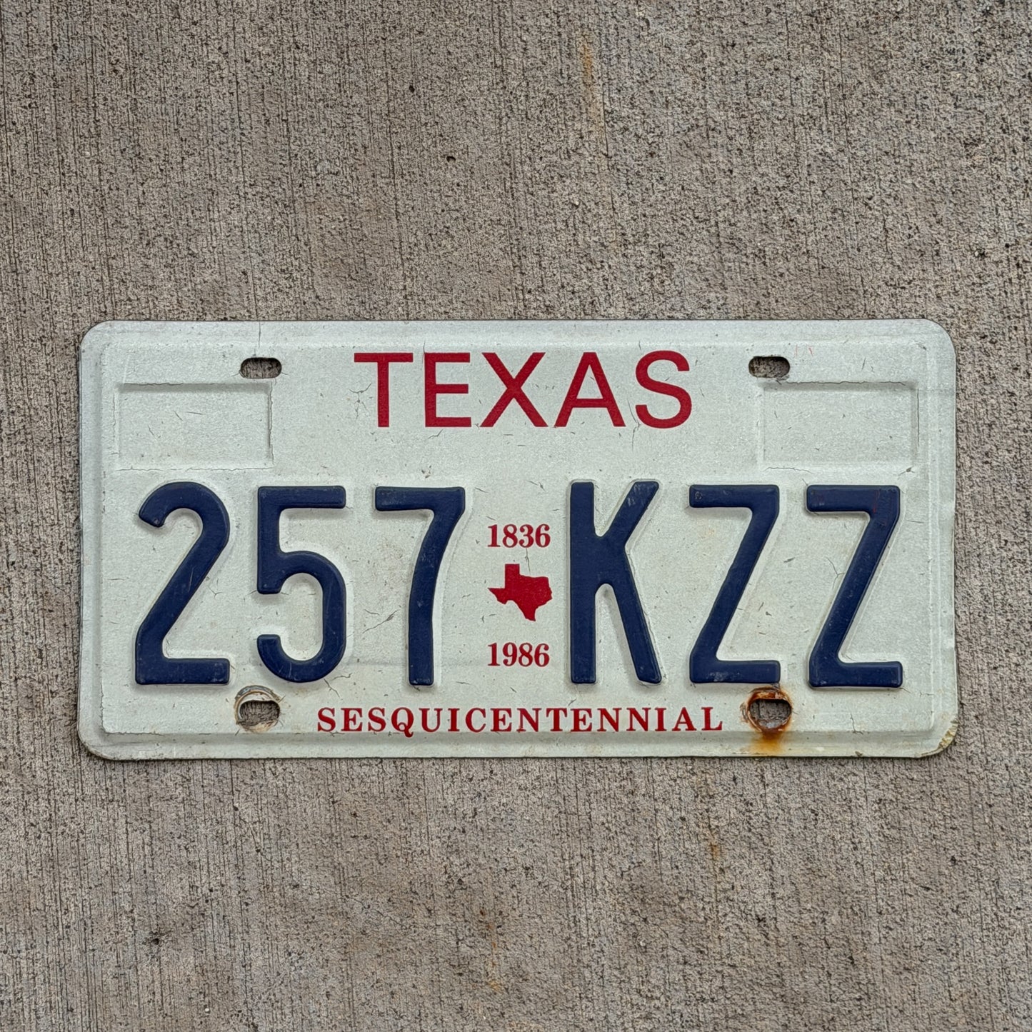 Photo of a 1985 Texas License Plate Auto Tag Garage Decor Vintage Sesquicentennial 257 KZZ with original patina