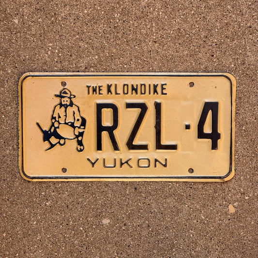 Photo of a 1985 Yukon License Plate Auto Tag Garage Decor Vintage Gold Prospector Graphic RZL 4