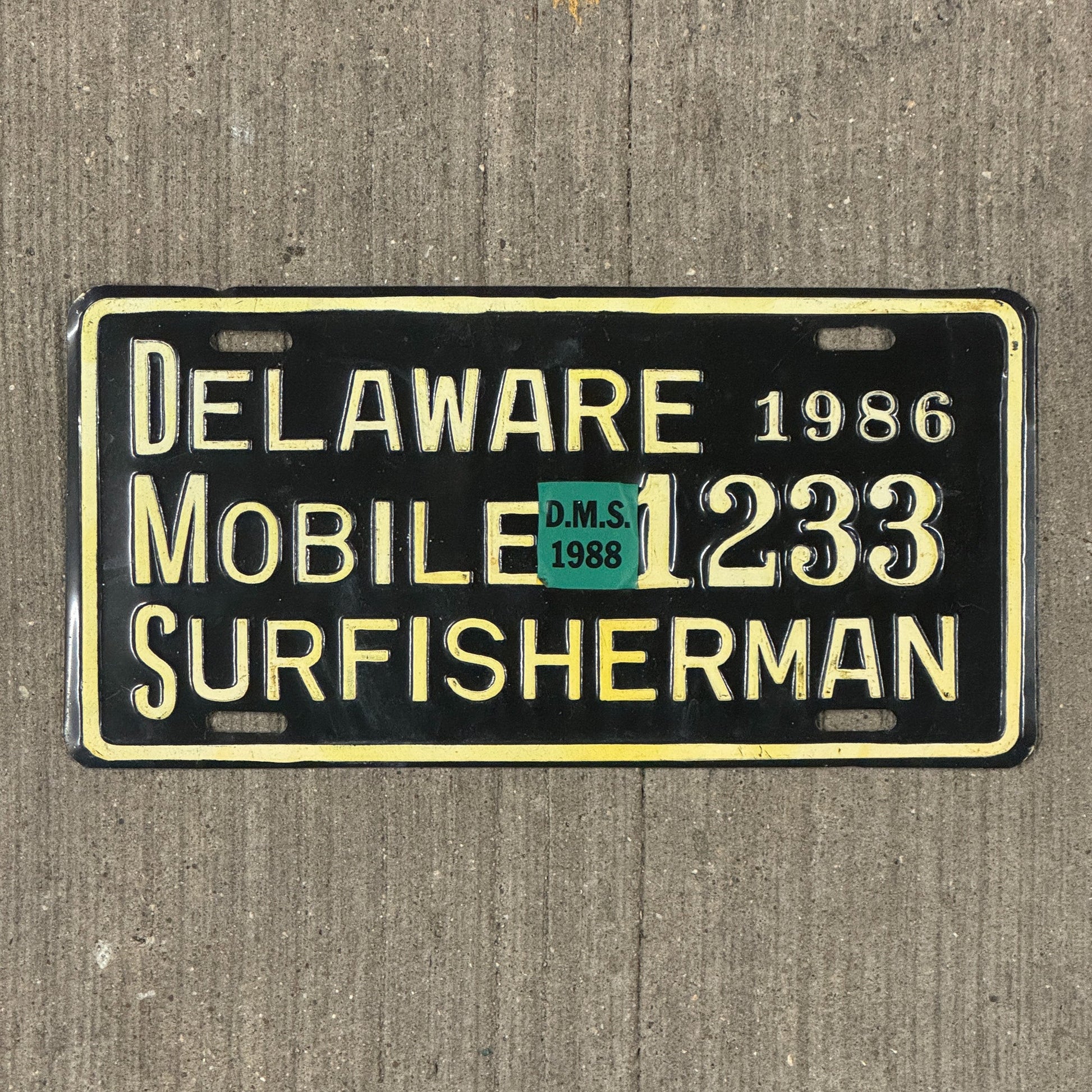 Photo of a 1986 1988 Delaware Mobile Surfisherman License Plate Auto Tag Garage Decor Vintage Surf Fisherman 1233 with original patina