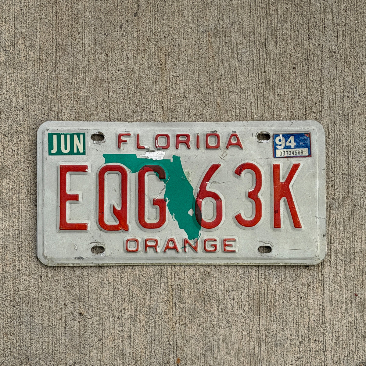 Photo of a 1986 1994 Florida License Plate Auto Tag Garage Decor Vintage Orange County EQG 63K with original patina