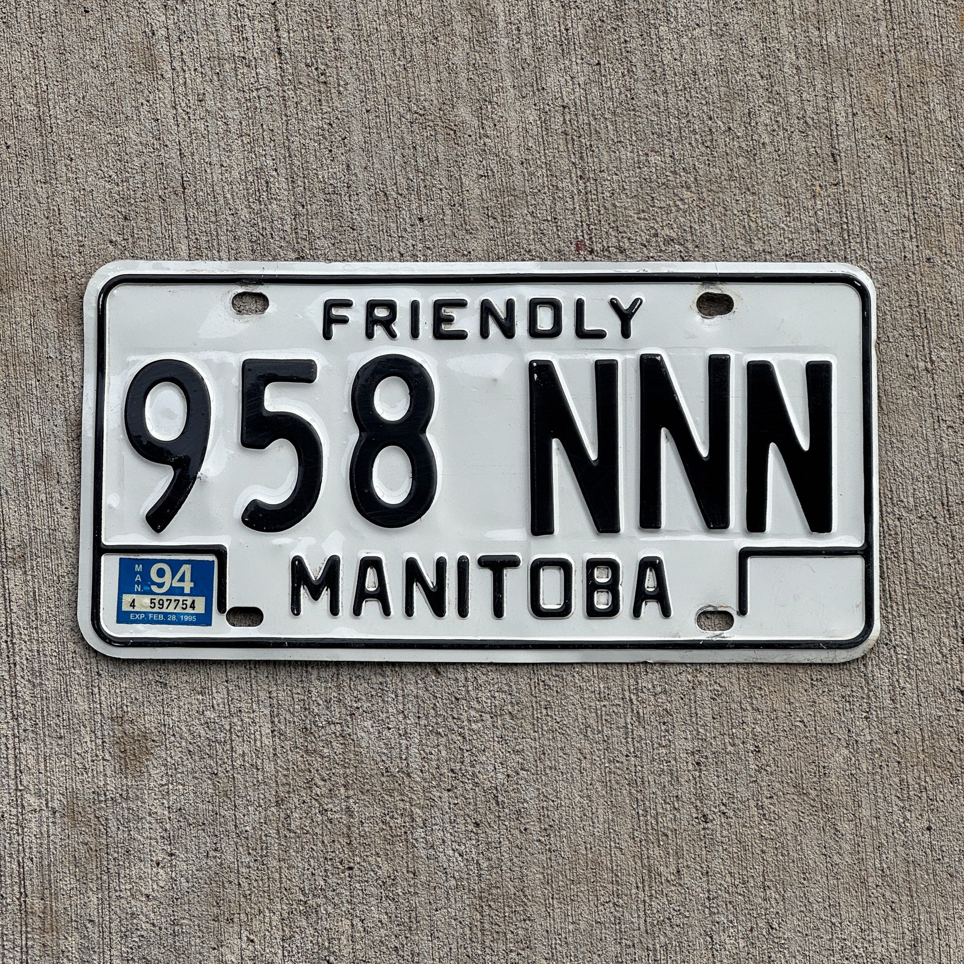 Photo of a 1986 1994 Manitoba License Plate Auto Tag Garage Decor Vintage Repeat Repeating 958 NNN with original patina