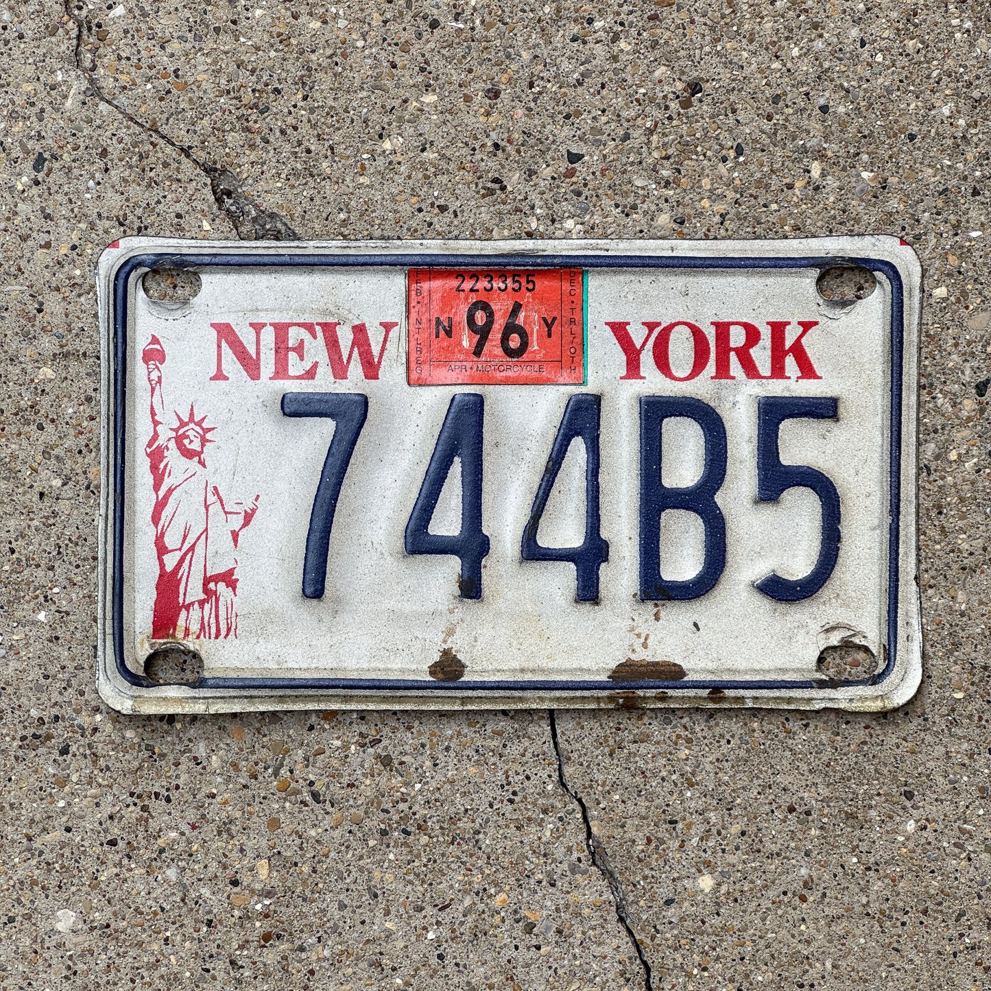 Photo of a 1986 1996 New York Motorcycle License Plate Auto Tag Garage Decor Vintage 744B5 with original patina