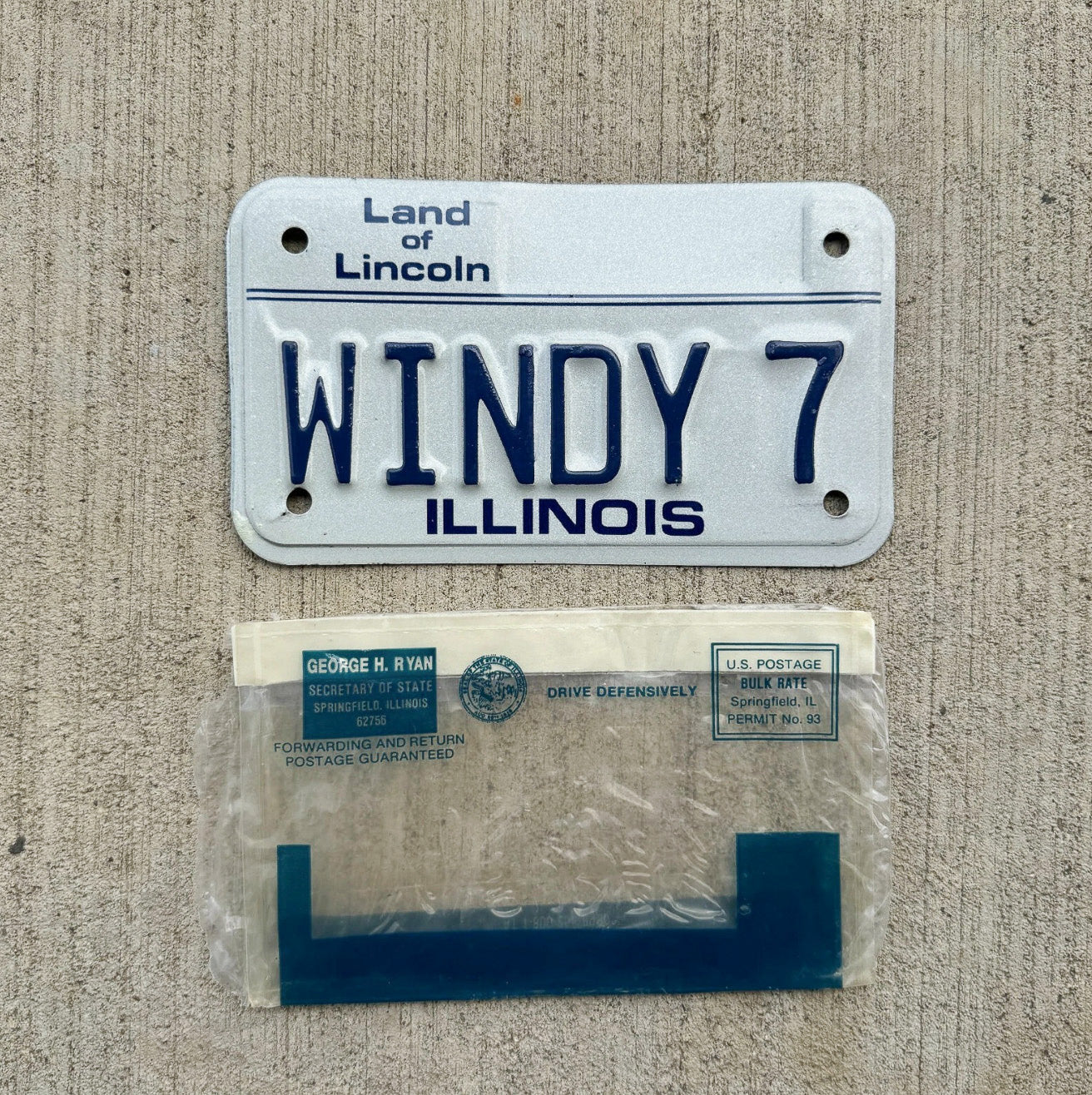 Photo of a 1986 Illinois Motorcycle Vanity License Plate Auto Tag Garage Decor Vintage Windy City Chicago With Envelope WINDY 7 with original patina