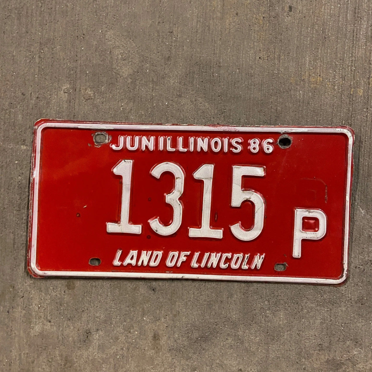 Photo of a 1986 Illinois Truck License Plate Auto Tag Garage Decor Vintage 1315 P with original patina