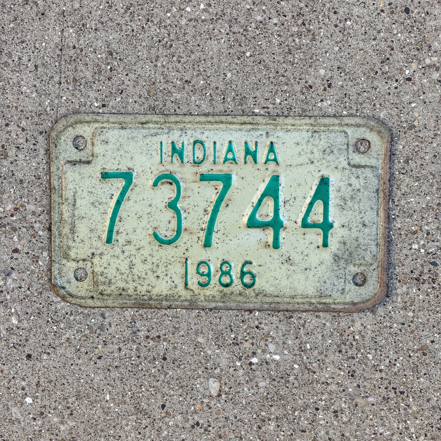Photo of a 1986 Indiana Motorcycle License Plate Auto Tag Garage Decor Vintage 73744 with original patina