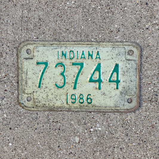 Photo of a 1986 Indiana Motorcycle License Plate Auto Tag Garage Decor Vintage 73744 with original patina