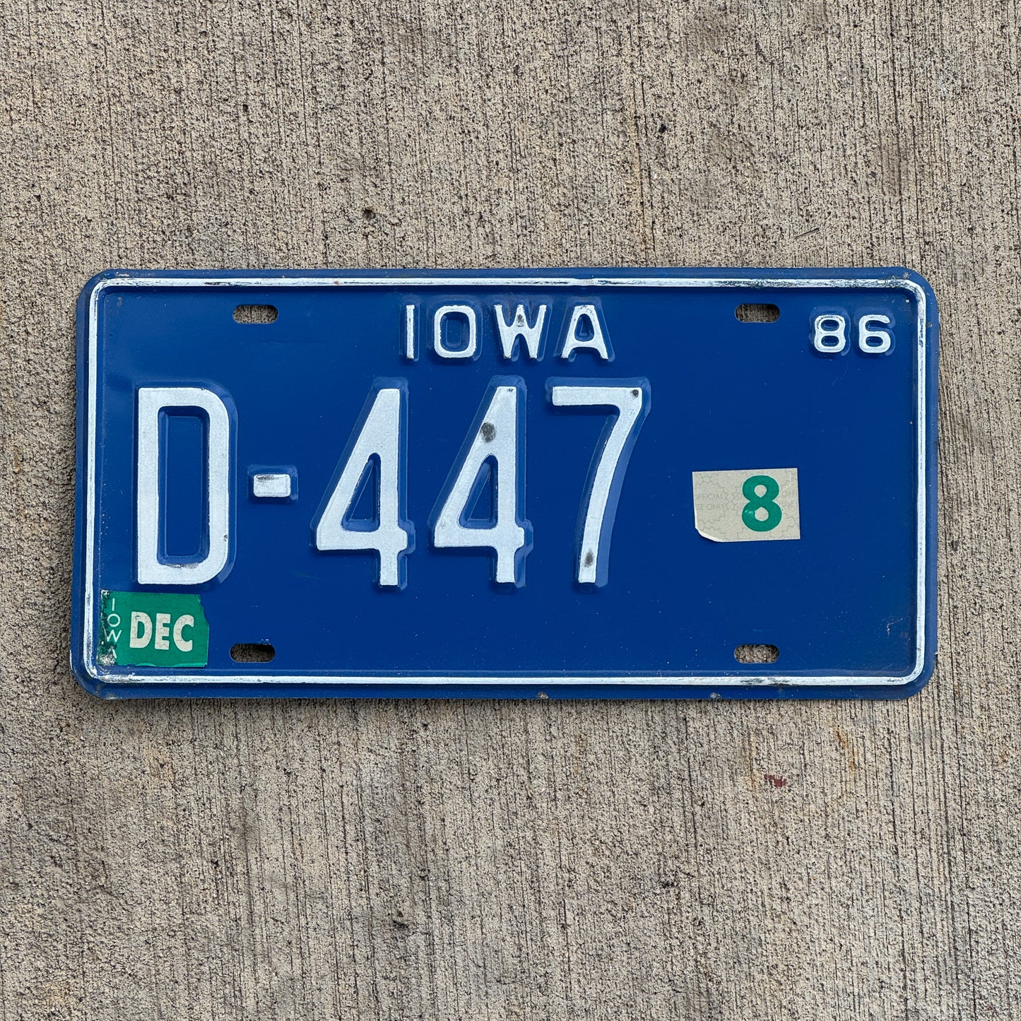Photo of a 1986 Iowa Dealer License Plate Auto Tag Garage Decor Vintage D 447 with original patina