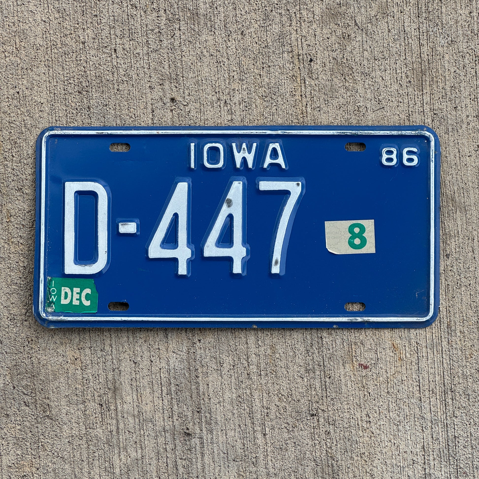 Photo of a 1986 Iowa Dealer License Plate Auto Tag Garage Decor Vintage D 447 with original patina