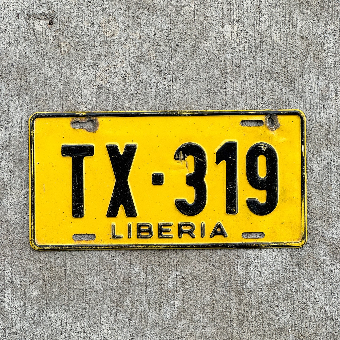 Photo of a 1986 Liberia Taxi License Plate Auto Tag Garage Decor Vintage TX 319 with original patina