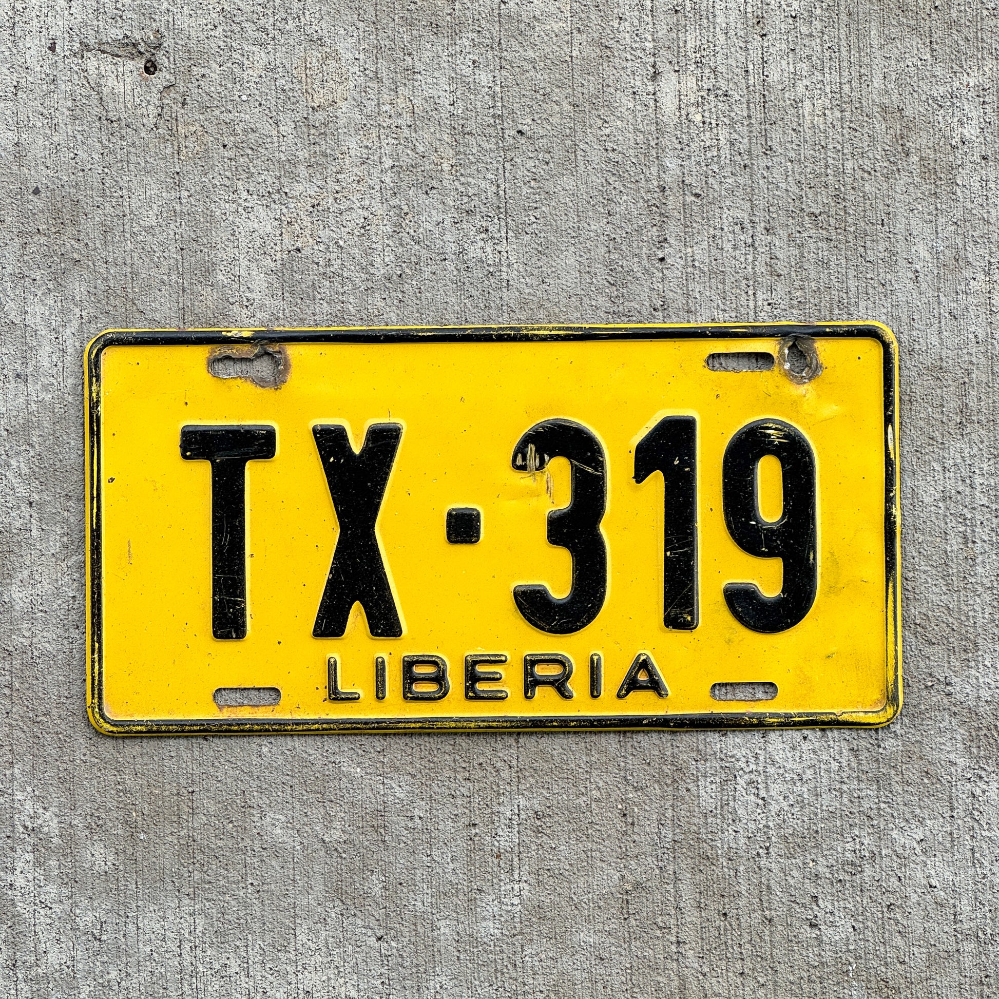 Photo of a 1986 Liberia Taxi License Plate Auto Tag Garage Decor Vintage TX 319 with original patina