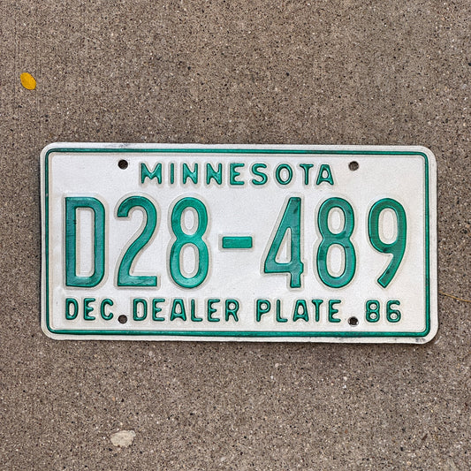 Photo of a 1986 Minnesota Dealer License Plate Auto Tag Garage Decor Vintage D 28 489 with original patina