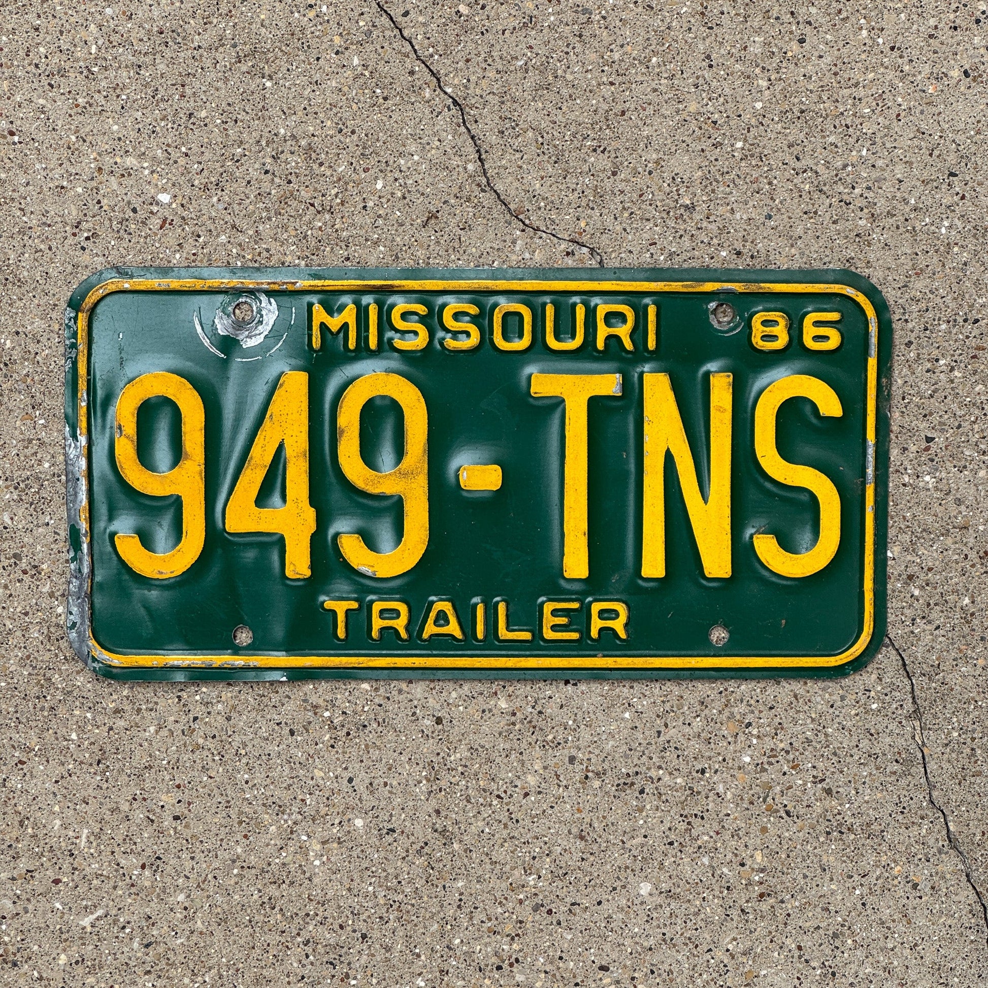Photo of a 1986 Missouri Trailer License Plate Auto Tag Garage Decor Vintage 949 TNS