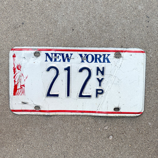 Photo of a 1986 New York Press License Plate Auto Tag Garage Decor Vintage News Newspaper 212 with original patina
