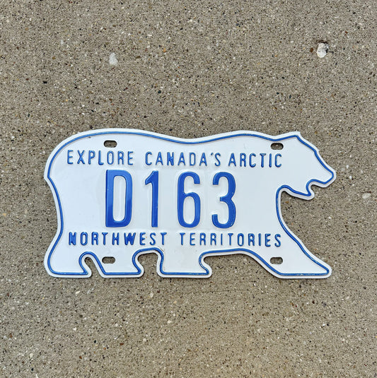 Photo of a 1986 Northwest Territories Dealer License Plate Auto Tag Garage Decor Vintage Polar Bear D 163 with original patina