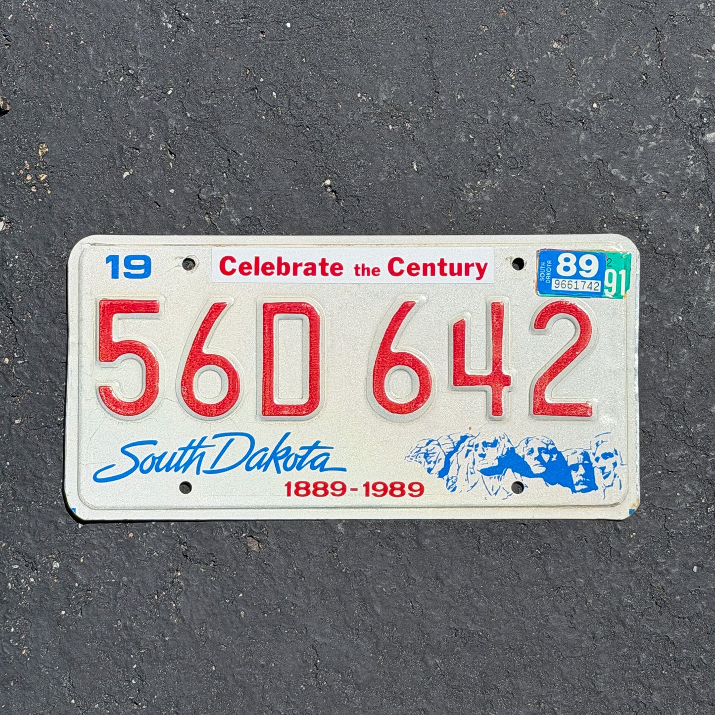 Photo of a 1987 1989 South Dakota License Plate Auto Tag Garage Decor Vintage Centennial 56D 642 with original patina