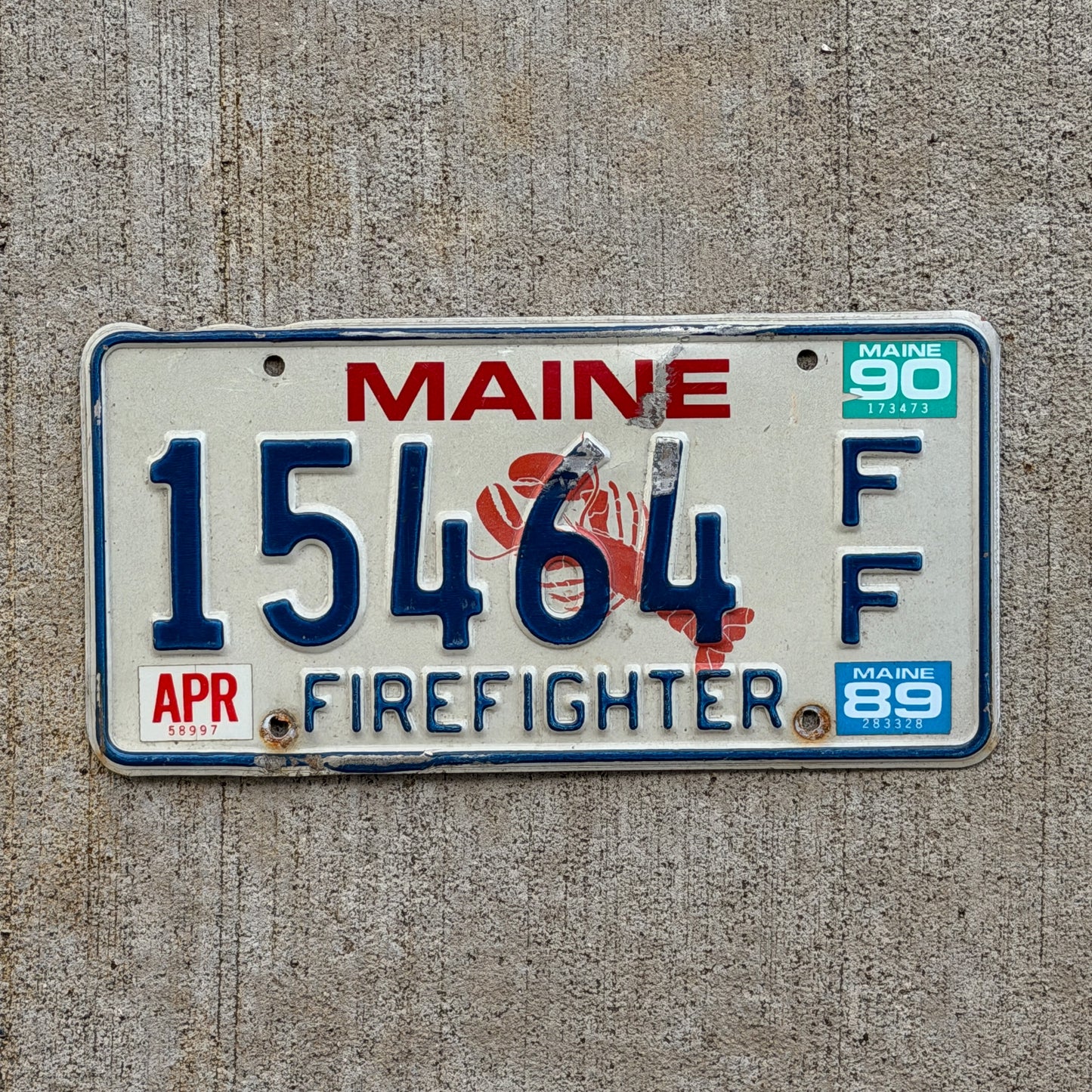Photo of a 1987 1990 Maine Firefighter License Plate Auto Tag Garage Decor Vintage Lobster 15464 FF with original patina