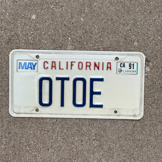 Photo of a 1987 1991 California Vanity License Plate Auto Tag Garage Decor Vintage Native American Indian Tribe OTOE with original patina