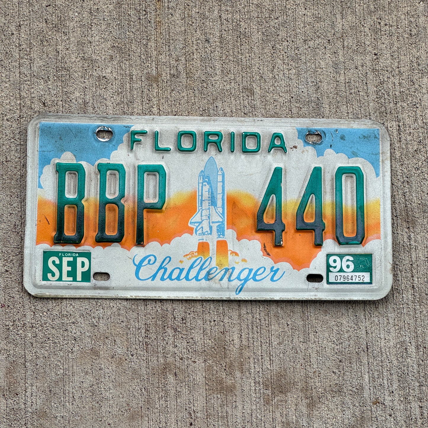 Photo of a 1987 1996 Florida Graphic / Specialty License Plate Auto Tag Garage Decor Vintage Challenger Spaceship BBP 440 with original patina