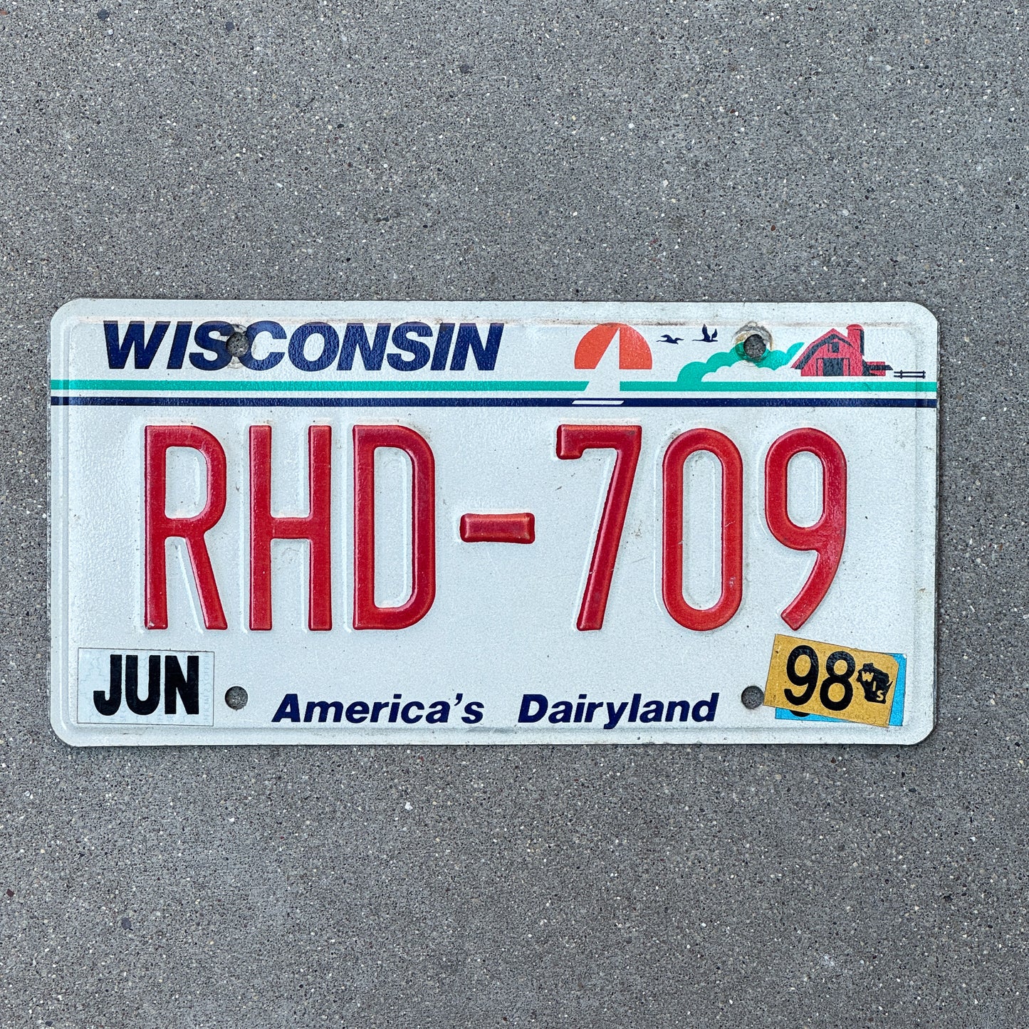Photo of a 1987 1998 Wisconsin License Plate Auto Tag Garage Decor Vintage RHD 709 with original patina