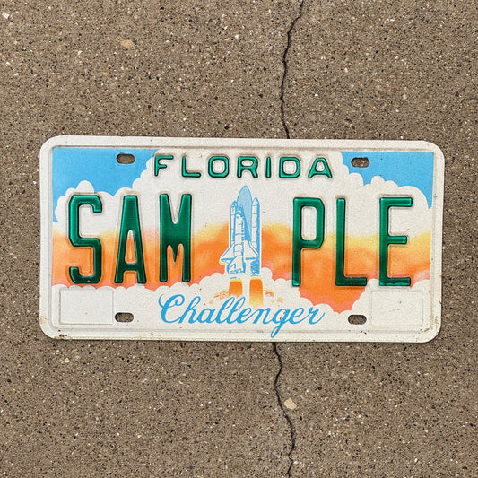 Photo of a 1987 Florida SAMPLE License Plate Auto Tag Garage Decor Vintage Challenger Space SAM-PLE