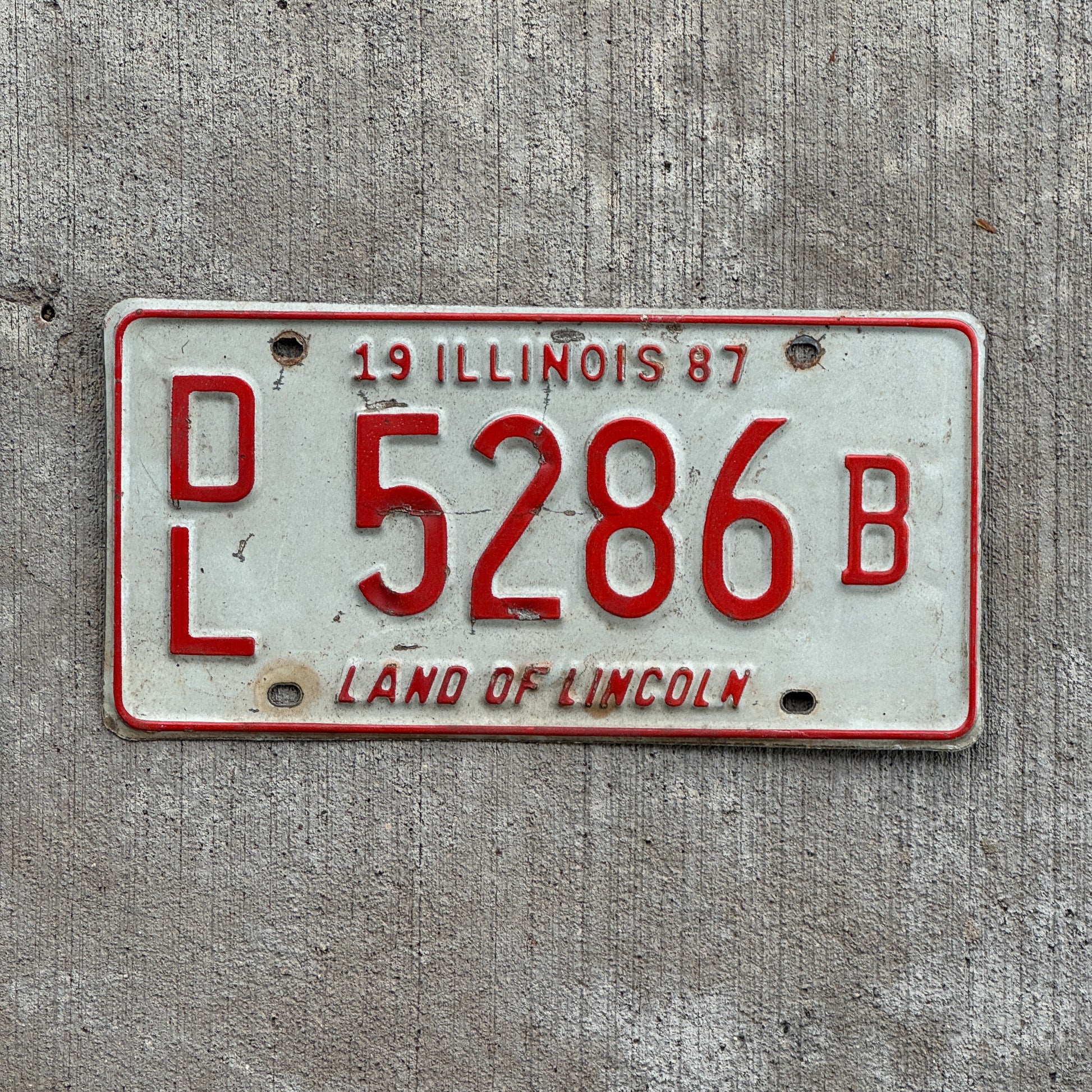 Photo of a 1987 Illinois Dealer License Plate Auto Tag 1 Vintage Garage 5286 B with original patina