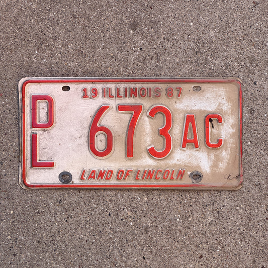 Photo of a 1987 Illinois Dealer License Plate Auto Tag 2 Vintage Garage Merritt's Sterling Ford Mercury Lincoln Dealer 673 AC with original patina