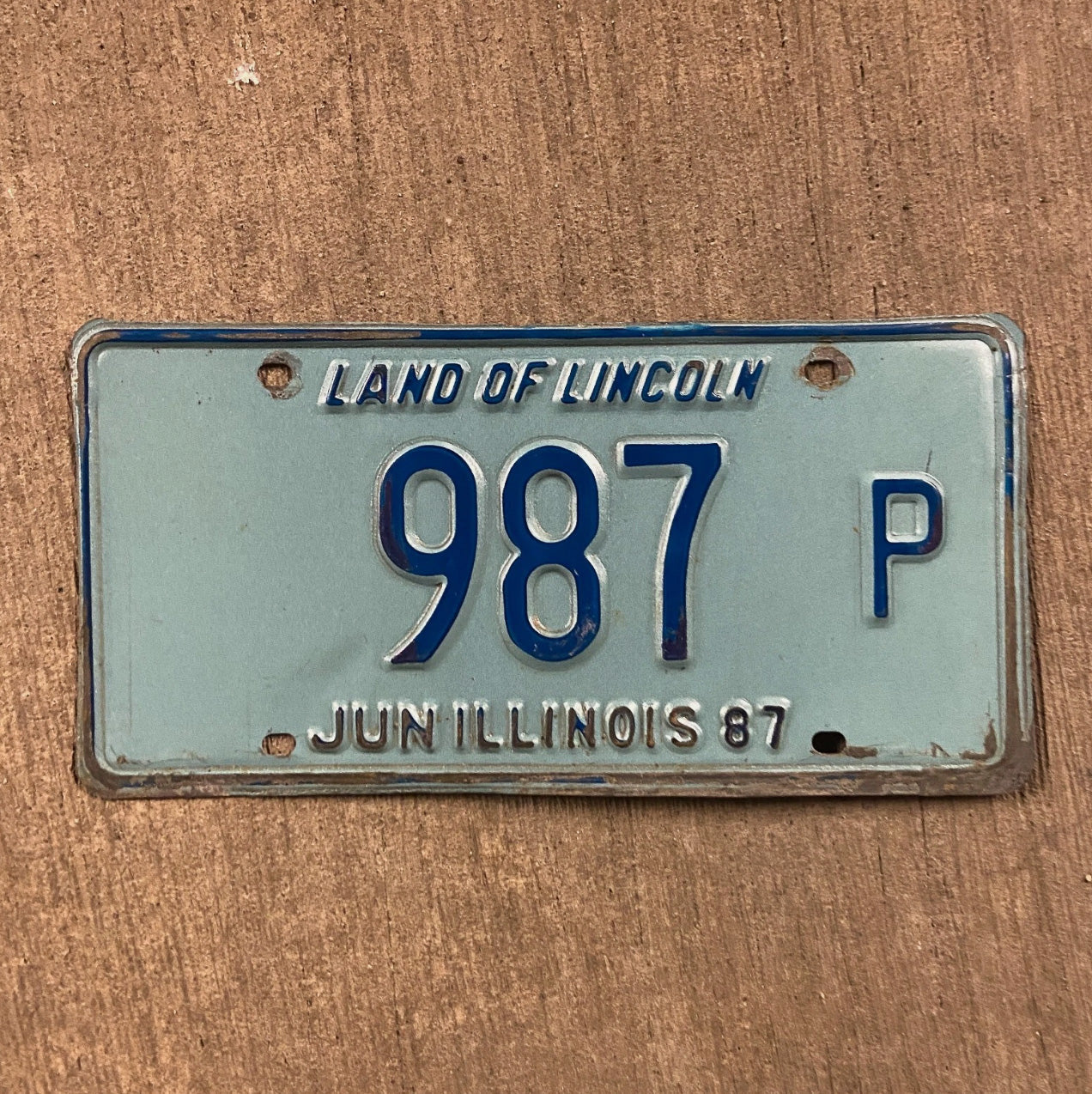 Photo of a 1987 Illinois Truck License Plate Auto Tag Garage Decor Vintage 987 P with original patina
