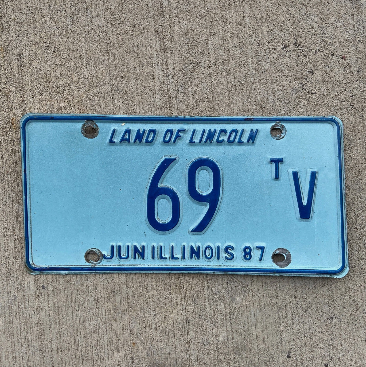 Photo of a 1987 Illinois Truck Tractor License Plate Auto Tag Garage Decor Vintage Low Number Two Digit 69 TV with original patina