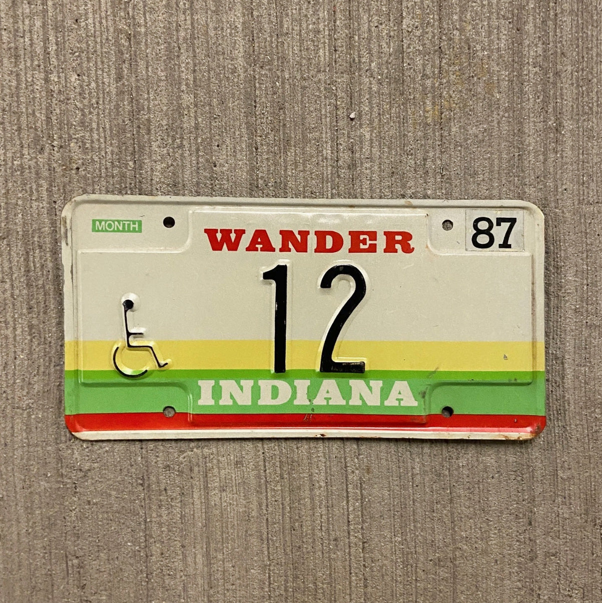 Photo of a 1987 Indiana Handicap License Plate Auto Tag Garage Decor Vintage Low Number Two Digit 12 with original patina