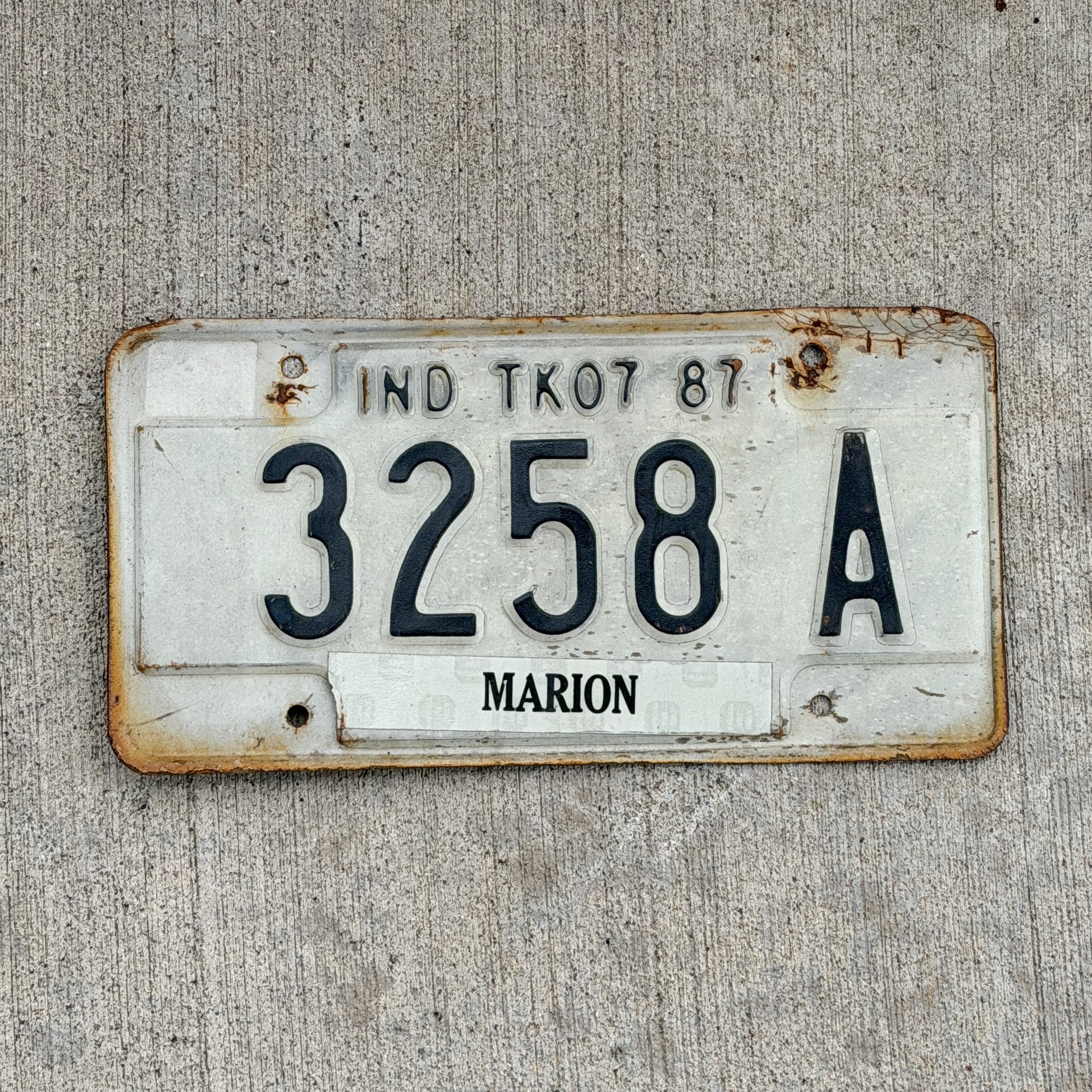 Photo of a 1987 Indiana Truck License Plate Auto Tag Garage Decor Vintage 3258 A with original patina