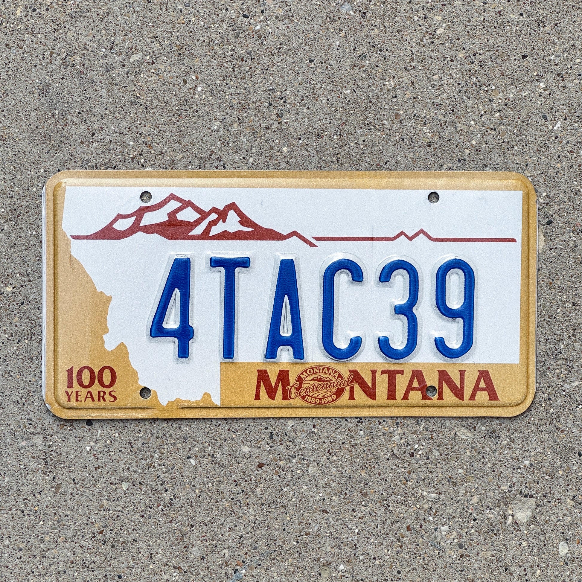 Photo of a 1987 Montana License Plate Auto Tag 1 Vintage Garage Centennial 4 TAC 39 with original patina