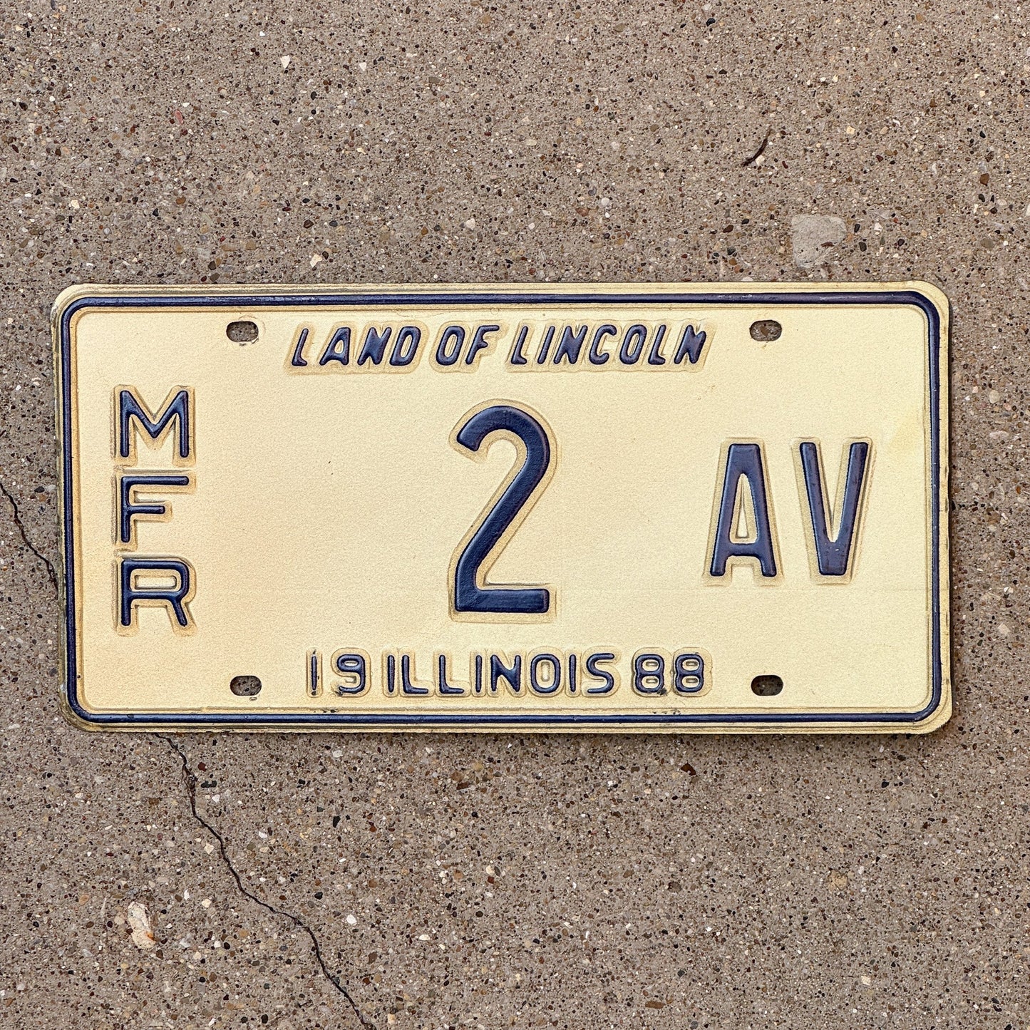 Photo of a 1988 Illinois Manufacturer License Plate Auto Tag Garage Decor Vintage 2 AV with original patina