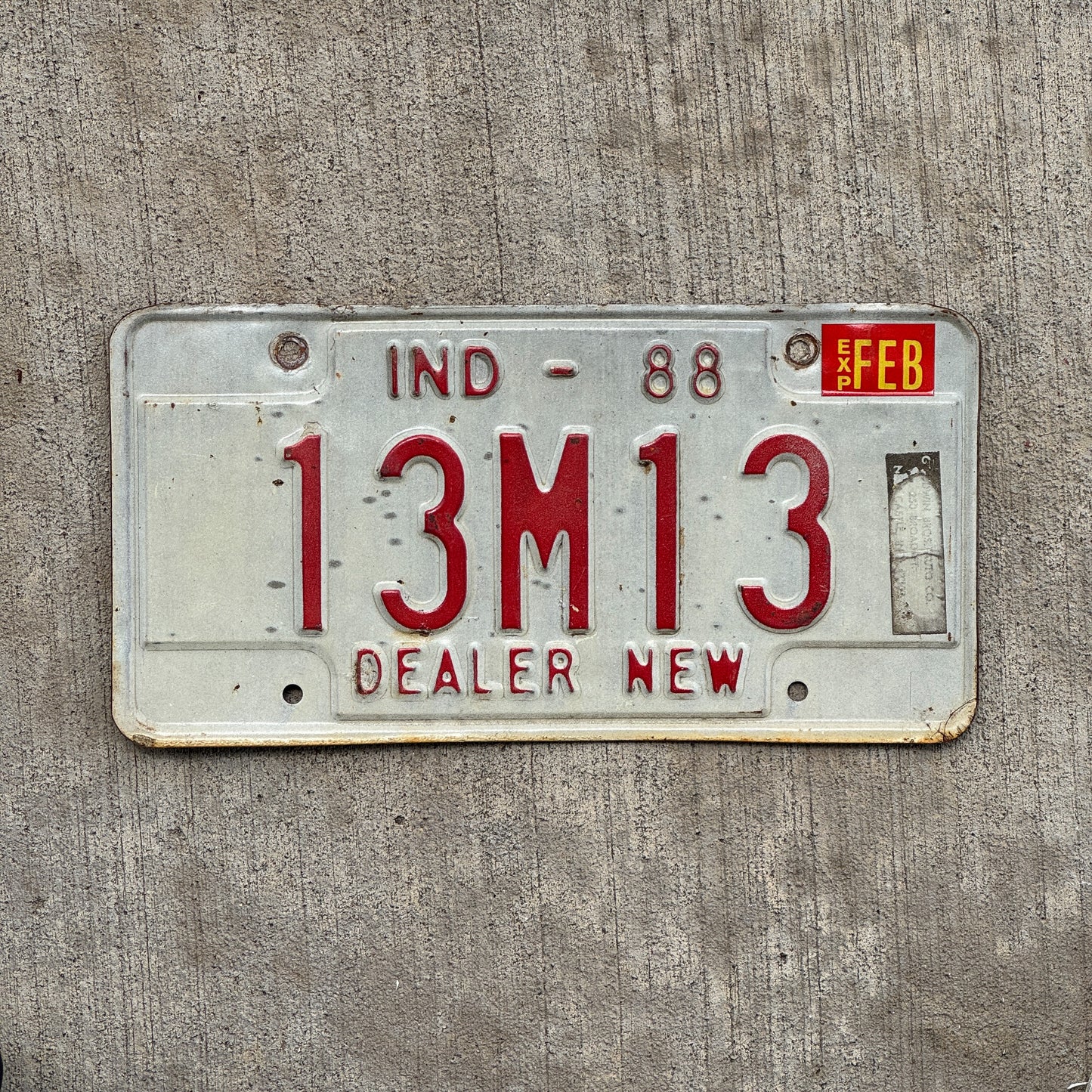 Photo of a 1988 Indiana Dealer License Plate Auto Tag Garage Decor Vintage New Car Dealer Nice Number 13 M 13 with original patina